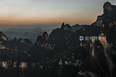 Aerial view of Tianmen (天门) mountain roads curving in the pooling fog, Hunan Province (湖南省), China